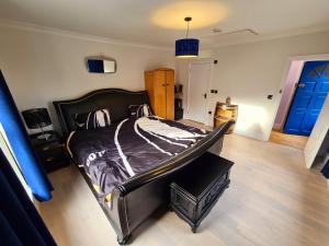 a bedroom with a bed in a room with a blue door at Southsea Royale Studio, James Bond, Parking, Seafront in Portsmouth