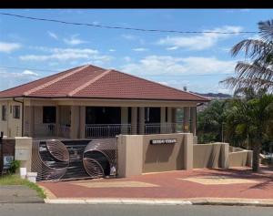 a house with two large metal sculptures in front of it at CONDO VILLAS ON MARINE DRIVE in Durban