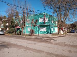 a green building on the side of a street at Hotel Embassy in Miramar