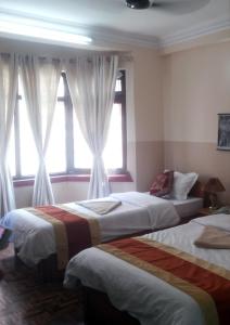 Postel nebo postele na pokoji v ubytování Kathmandu Peace Guesthouse
