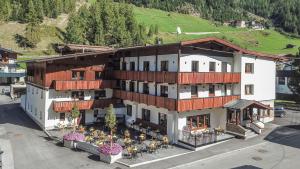 an overhead view of a building with tables in front of it at first mountain Hotel Ötztal in Längenfeld