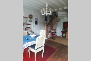 a dining room with a table and two chairs at la maison de Caroline in Saint-Valéry-en-Caux +3 photos