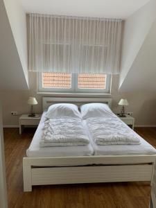 Postel nebo postele na pokoji v ubytování Ferienhaus Ankerplatz