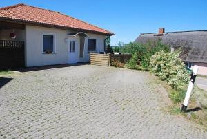a brick driveway in front of a house at Ferienhaus Guenter in Gager