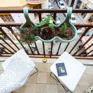 een balkon met een bank en een boek bij B&B Bandiera 77 in Palermo