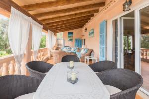 a dining room with a table and chairs on a porch at Villa Dolce Vita in Portocolom