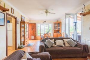 a living room with a couch and a table at Villa Dolce Vita in Portocolom