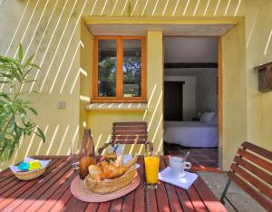 a table with a basket of food on a patio at Domaine De Fraisse in Leuc