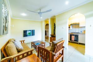 a living room with two chairs and a table at Shakespeare Court Serviced Apartments in Lusaka +36 photos