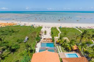 an aerial view of a beach with people in the water at Pousada de Charme Villa Italiana - Pé na Areia in São Miguel dos Milagres