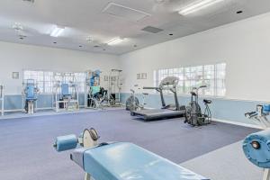 a gym with several treadmills and exercise bikes at After Dune Delight in New Smyrna Beach