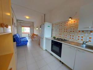 a kitchen with a sink and a stove top oven at Pagoda 4 in Lido di Pomposa