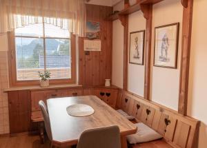 a dining room with a table and a window at Apartma Gaby in Bled