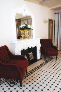 a living room with two chairs and a fireplace at Hotel Meltzer Apartments in Tallinn