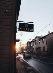 a sign for a methler on the side of a street at Hotel Meltzer Apartments in Tallinn