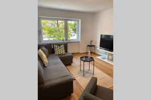 Televízia a/alebo spoločenská miestnosť v ubytovaní Wohnung 2 in zentraler Lage im Rheintal