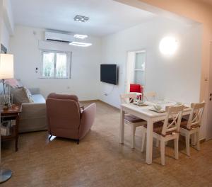 a living room with a table and chairs and a couch at Eyni Lovely Boutique Apartment in Jerusalem