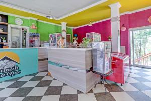 a restaurant with pink and green walls and a counter at Collection O 90617 Rumah Oma Opa Syariah in Bandung +41 photos