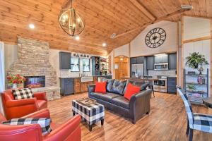a living room with a couch and a fireplace at Modern Cabin with Spacious Deck, BBQ, and Pergola! in Broken Bow