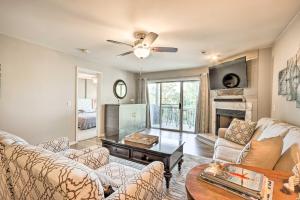 a living room with a couch and a table at Lake of the Ozarks Home with Balcony and Grill! in Osage Beach