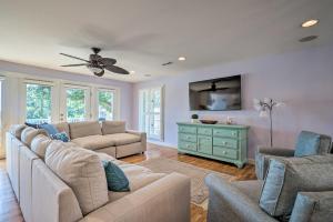 a living room with couches and a ceiling fan at Waterfront Hampstead Home Dock and Waterway Access! in Hampstead