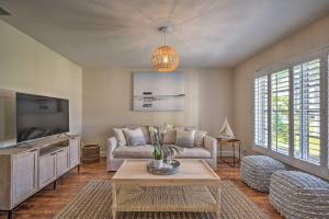a living room with a couch and a tv at Naples Oasis with Screened Pool, Bike to Beach! in Naples