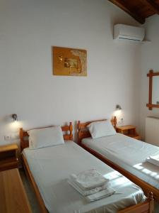 two beds sitting next to each other in a room at villa axiothea in Skiathos