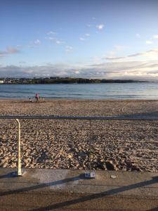 a volleyball net on a beach with the water at Malin View Apartments PORT71 in Portrush