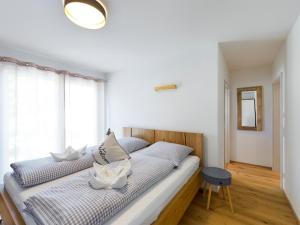 a bedroom with a large bed with a window at Lieblingsort in Garmisch-Partenkirchen