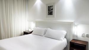 Cama ou camas em um quarto em Plaza São Rafael Hotel