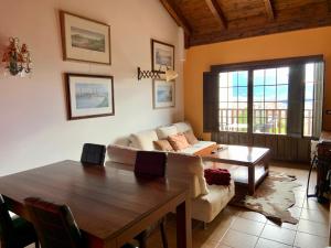 a living room with a couch and a table at Badaguás (Jaca) - Duplex en el Pirineo in Jaca