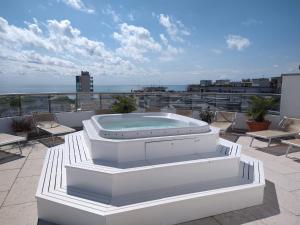 a hot tub sitting on top of a balcony at Hotel Centrale in Lido di Jesolo