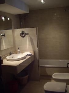 a bathroom with a sink and a toilet and a shower at Port D'Aro in Platja d'Aro