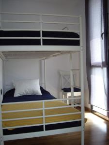 a bedroom with two bunk beds and a window at Port D'Aro in Platja d'Aro