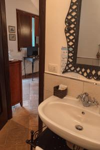 bagno con lavandino e specchio di Agriturismo Il Puntoncino a Marsiliana