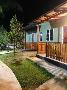 a house with a wooden fence in front of it at BB Durio Chalet in Kampong Banggol Binjai