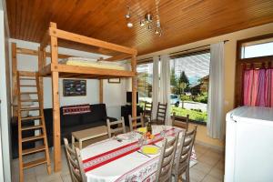 a dining room with a table and a bunk bed at Appartements Le Soleil in LʼHuez