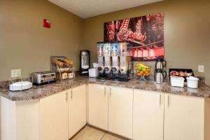 a kitchen with a counter top with food on it at Super 8 by Wyndham Sandusky in Sandusky