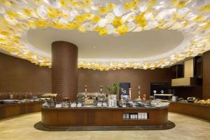 a restaurant with a large ceiling with a large chandelier at Wyndham Grand Istanbul Europe in Istanbul