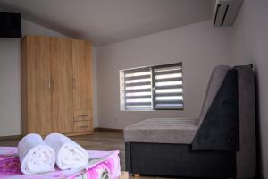 a bedroom with a bed and a window and a mattress at Апартаменти ЗДРАВЕ in Sapareva Banya +101 photos