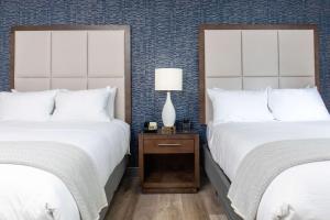 
a hotel room with two beds and two lamps at Haywood Park Hotel, Ascend Hotel Collection in Asheville
