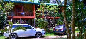 a white car parked in front of a house at Luck Uyana Cabana Pinnawala in Pinnawala