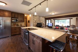 a kitchen with a counter top and a living room at Hood View 30 Day Minimum cabin in Mount Hood
