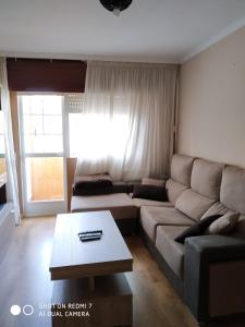 a living room with a couch and a coffee table at Gonsa 1 in Padrón