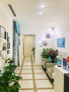 a room with a long hallway with plants at KAMBAL LUXURY SUITES in Rome