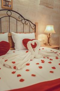 a bed with a couple of hearts on it at Rose Valley Hotel in Göreme