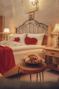 a plate of food on a table in a bedroom at Rose Valley Hotel in Goreme