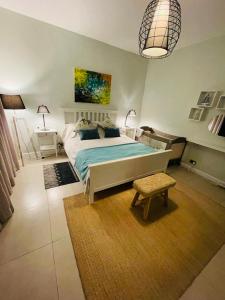 a bedroom with a bed and a table and a lamp at Beachcove Apartment 2 in Pereybere