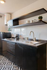 a kitchen with a sink and a counter top at Casa Guillermina in Durango