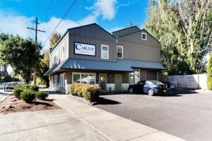 a building with a car parked in a parking lot at Johnson Street Studio in McMinnville